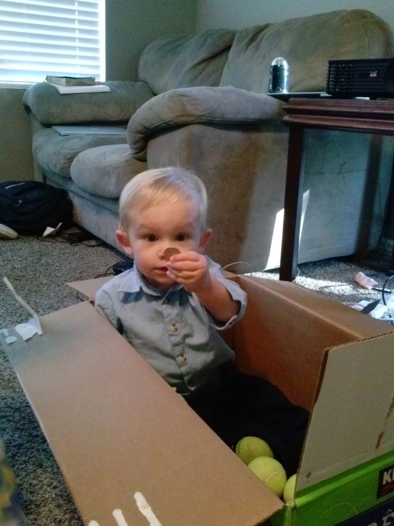 This is Carter in a box with one of the things he loves right now--money! He will play with coins forever. The other things he loves are fish and balls.