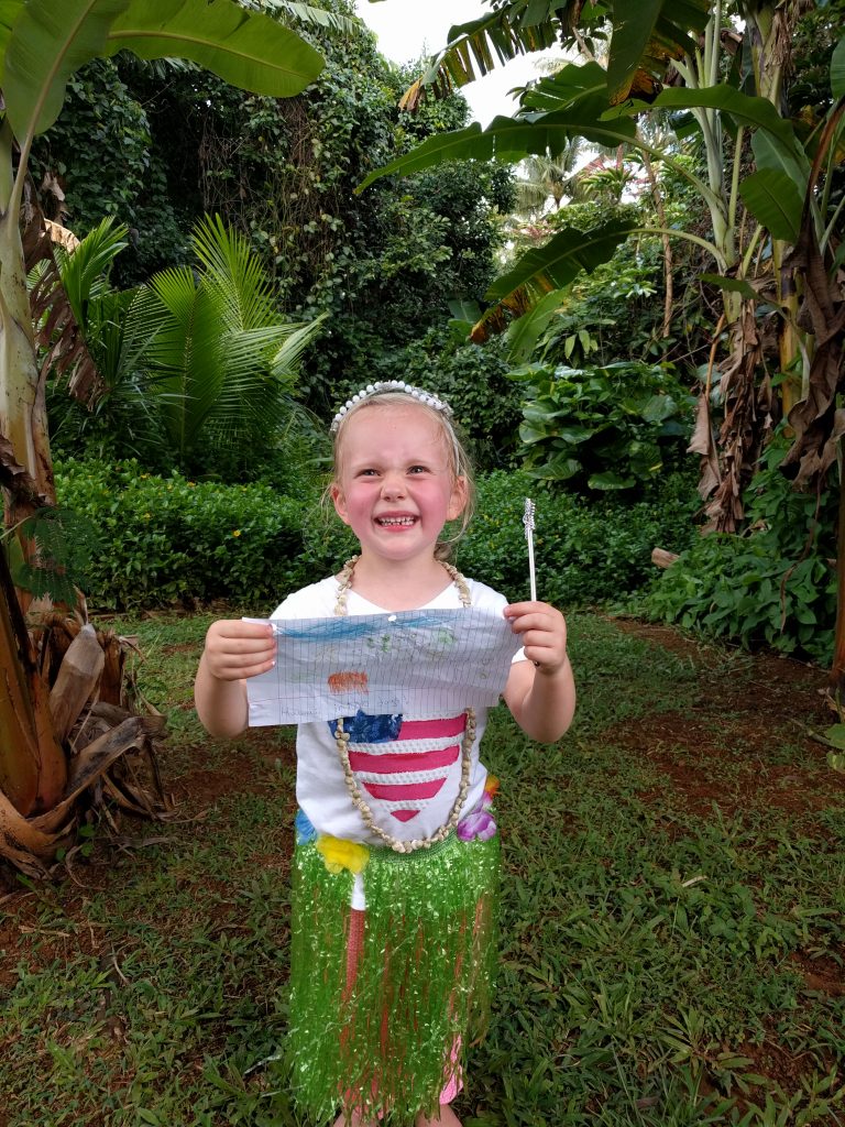 This picture was taken approximately 10 minutes after we arrived at our "Hawaii House." Fay drew this picture and planned this outfit days before we left, and she said that she MUST have her picture taken in Hawaii with her picture of Hawaii.